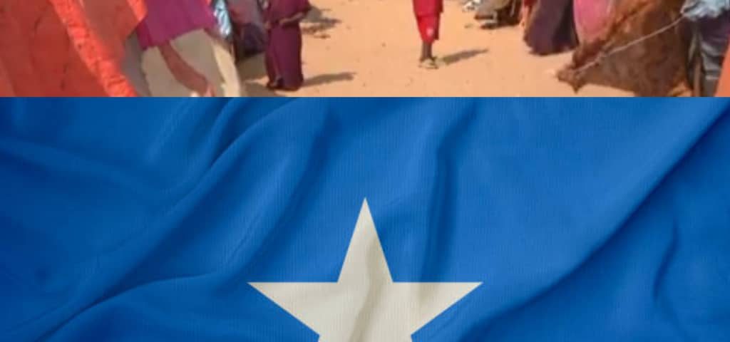 A picture of tents belonging to people displaced by drought, with the Somali flag.